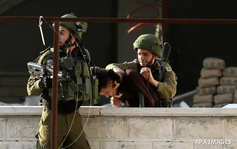 Israeli security forces arrest aPalestinian protester during clashes near the Huwara checkpoint, south of Nablus in the Israeli-occupied West Bank, on December 15, 2017, as protests continue in the region amid anger over...