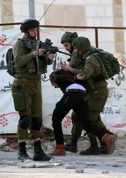 Israeli security forces arrest aPalestinian protester during clashes near the Huwara checkpoint, south of Nablus in the Israeli-occupied West Bank, on December 15, 2017, as protests continue in the region amid anger over...