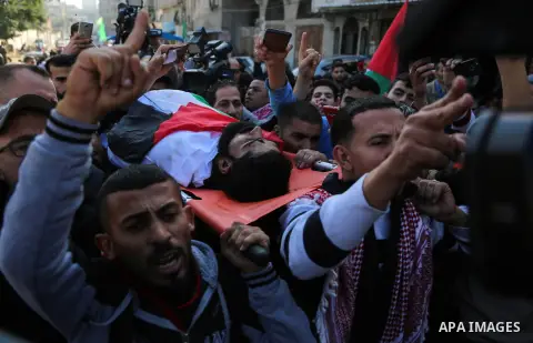 Palestinians carry the body of 29-year-old Ibrahim Abu Thurayeh during his funeral in Gaza City on December 16, 2017 after he was shot dead in clashes between Israeli forces and protesters along the Gaza-Israel border, a...