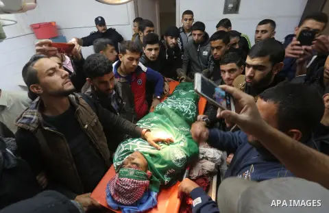 Palestinians gather around the body of Yasser Sukar as they mourn during his funeral in Gaza City on December 16, 2017 after he was shot dead in clashes between Israeli forces and protesters along the Gaza-Israel border,...