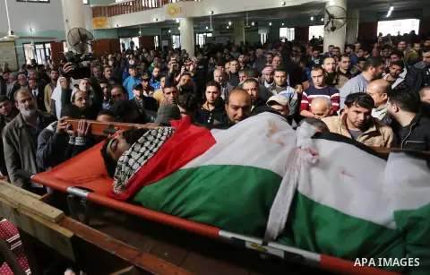 Palestinians carry the body of 29-year-old Ibrahim Abu Thurayeh during his funeral in Gaza City on December 16, 2017 after he was shot dead in clashes between Israeli forces and protesters along the Gaza-Israel border, a...