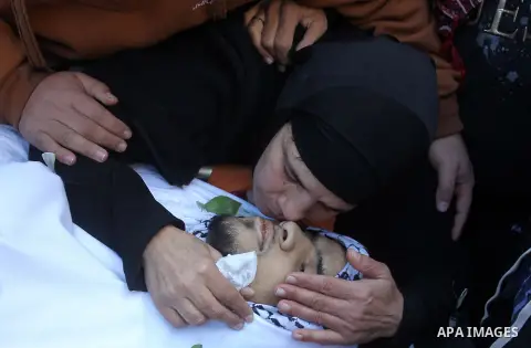 The mother of Mohammad Aqel, a Palestinian man who was killed after carrying out a stabbing attack on an Israeli soldier, mourns during the funeral of their brother in the village of Beit Ula, near Hebron in the Israeli...