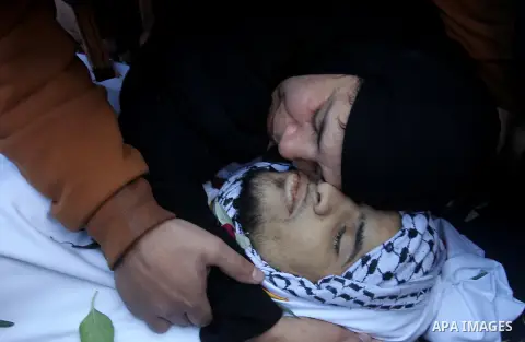 The mother of Mohammad Aqel, a Palestinian man who was killed after carrying out a stabbing attack on an Israeli soldier, mourns during the funeral of their brother in the village of Beit Ula, near Hebron in the Israeli...
