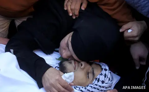 The mother of Mohammad Aqel, a Palestinian man who was killed after carrying out a stabbing attack on an Israeli soldier, mourns during the funeral of their brother in the village of Beit Ula, near Hebron in the Israeli...