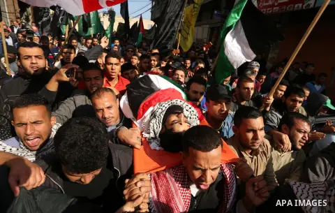 Palestinians carry the body of 29-year-old Ibrahim Abu Thurayeh during his funeral in Gaza City on December 16, 2017 after he was shot dead in clashes between Israeli forces and protesters along the Gaza-Israel border, a...