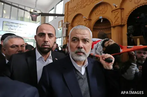 Hamas Chief Ismail Haniyeh carries the body of 29-year-old Ibrahim Abu Thurayeh during his funeral in Gaza City on December 16, 2017 after he was shot dead in clashes between Israeli forces and protesters along the Gaza-...