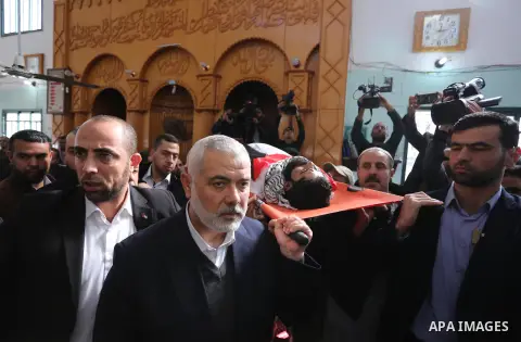 Hamas Chief Ismail Haniyeh carries the body of 29-year-old Ibrahim Abu Thurayeh during his funeral in Gaza City on December 16, 2017 after he was shot dead in clashes between Israeli forces and protesters along the Gaza-...