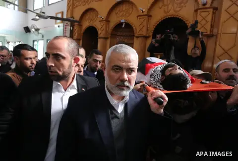Hamas Chief Ismail Haniyeh carries the body of 29-year-old Ibrahim Abu Thurayeh during his funeral in Gaza City on December 16, 2017 after he was shot dead in clashes between Israeli forces and protesters along the Gaza-...