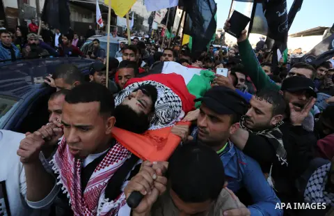 Palestinians carry the body of 29-year-old Ibrahim Abu Thurayeh during his funeral in Gaza City on December 16, 2017 after he was shot dead in clashes between Israeli forces and protesters along the Gaza-Israel border, a...