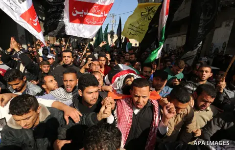 Palestinians carry the body of 29-year-old Ibrahim Abu Thurayeh during his funeral in Gaza City on December 16, 2017 after he was shot dead in clashes between Israeli forces and protesters along the Gaza-Israel border, a...