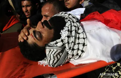 Palestinians carry the body of 29-year-old Ibrahim Abu Thurayeh during his funeral in Gaza City on December 16, 2017 after he was shot dead in clashes between Israeli forces and protesters along the Gaza-Israel border, a...