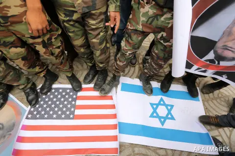 Palestinian supporters of the Popular Front for the Liberation of Palestine (PFLP) burn posters depicting U.S. President Donald Trump, an Israeli flag and a U.S. flag during a protest against U.S. President Donald Trump'...