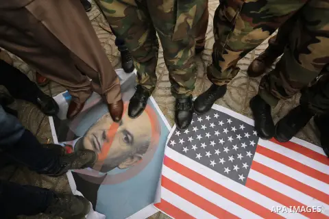 Palestinian supporters of the Popular Front for the Liberation of Palestine (PFLP) burn posters depicting U.S. President Donald Trump, an Israeli flag and a U.S. flag during a protest against U.S. President Donald Trump'...