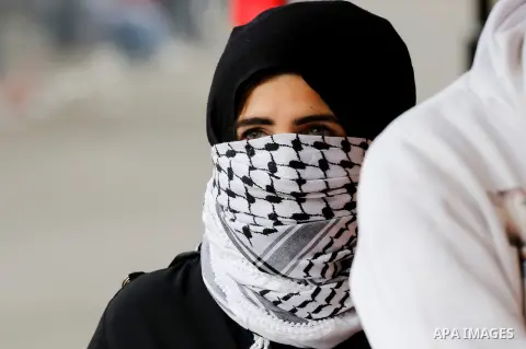 A Palestinian female protester looks on during clashes with Israeli security forces following a protest against U.S. President Donald Trump's decision to recognise Jerusalem as the capital of Israel, in the West Bank cit...