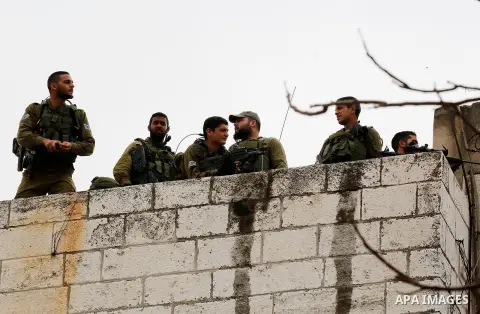 Israeli security forces take position during clashes with Palestinian protesters following a protest against U.S. President Donald Trump's decision to recognise Jerusalem as the capital of Israel, in the West Bank city o...