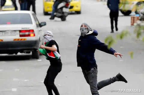 Palestinian protesters hurl stones toward Israeli security forces during clashes following a protest against U.S. President Donald Trump's decision to recognise Jerusalem as the capital of Israel, in the West Bank city o...