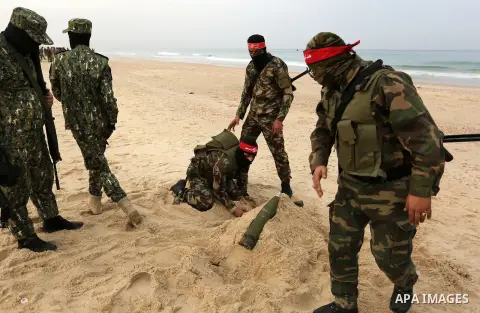 Palestinian militants of the Popular Front for the Liberation of Palestine (PFLP) take part in a military exercise, on beach in Khan Younis in the southern Gaza Strip, December 22, 2017. Photo by Ashraf Amra