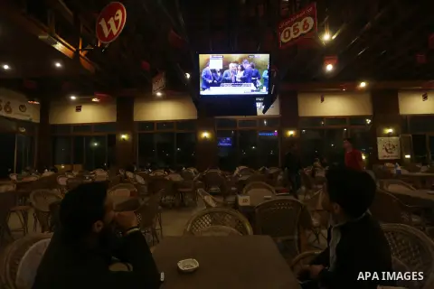 Palestinians watch a televised broadcast of the U.N. General Assembly emergency special session to vote on a draft resolution calling on the United States to withdraw its recognition of Jerusalem as Israel's capital, in...