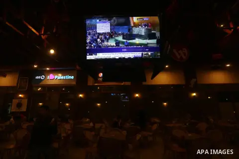 Palestinians watch a televised broadcast of the U.N. General Assembly emergency special session to vote on a draft resolution calling on the United States to withdraw its recognition of Jerusalem as Israel's capital, in...