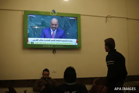Palestinians watch a televised broadcast of the U.N. General Assembly emergency special session to vote on a draft resolution calling on the United States to withdraw its recognition of Jerusalem as Israel's capital, in...