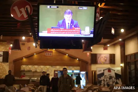 Palestinians watch a televised broadcast of the U.N. General Assembly emergency special session to vote on a draft resolution calling on the United States to withdraw its recognition of Jerusalem as Israel's capital, in...