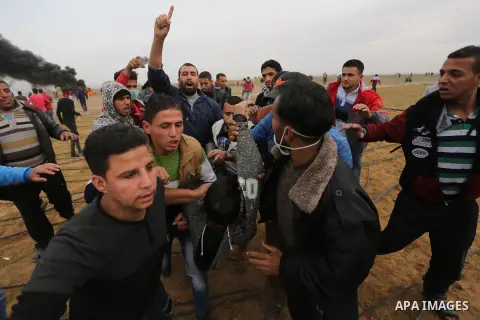 A wounded Palestinian protester is evacuated during clashes with Israeli security forces, at a protest as Palestinians call for a "Day of Rage" in response to U.S. President Donald Trump's recognition of Jerusalem as Isr...