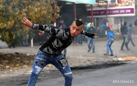 Palestinian protesters clash with Israeli security forces near the Huwara checkpoint south of Nablus in the Israeli-occupied West Bank, as Palestinians call for a "Day of Rage" in response to U.S. President Donald Trump'...