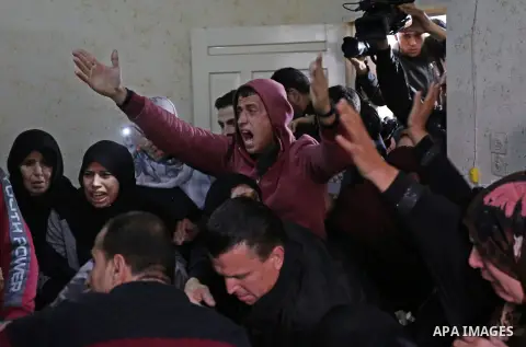 Palestinian relatives of Mohamed Moheisen, 29, who was killed during clashes with Israeli troops, mourn during his funeral in Gaza city on December 23, 2017. Two Palestinians were killed as youths clashed with Israeli so...