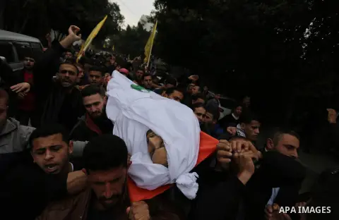 Palestinian mourners carry the body of Mohamed Moheisen, 29, who was killed during clashes with Israeli troops, during his funeral in Gaza city on December 23, 2017. Two Palestinians were killed as youths clashed with Is...