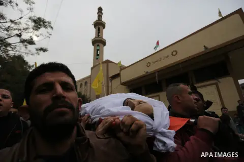 Palestinian mourners carry the body of Mohamed Moheisen, 29, who was killed during clashes with Israeli troops, during his funeral in Gaza city on December 23, 2017. Two Palestinians were killed as youths clashed with Is...