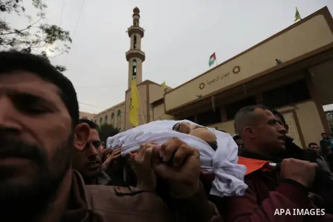 Palestinian mourners carry the body of Mohamed Moheisen, 29, who was killed during clashes with Israeli troops, during his funeral in Gaza city on December 23, 2017. Two Palestinians were killed as youths clashed with Is...
