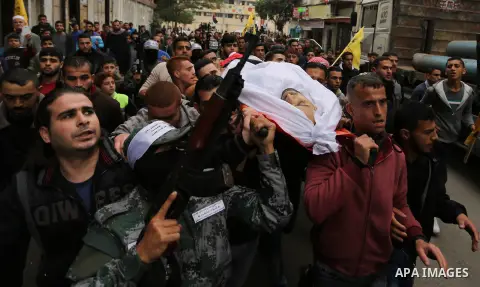Palestinian mourners carry the body of Mohamed Moheisen, 29, who was killed during clashes with Israeli troops, during his funeral in Gaza city on December 23, 2017. Two Palestinians were killed as youths clashed with Is...