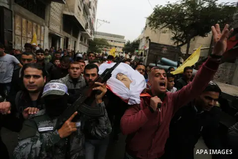 Palestinian mourners carry the body of Mohamed Moheisen, 29, who was killed during clashes with Israeli troops, during his funeral in Gaza city on December 23, 2017. Two Palestinians were killed as youths clashed with Is...