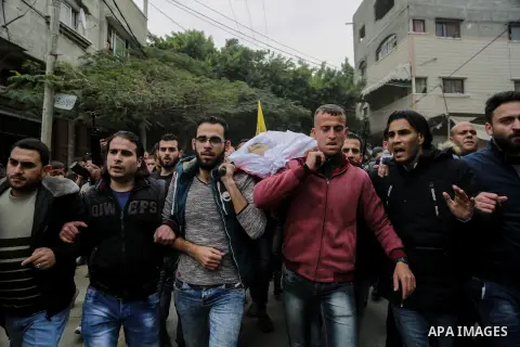 Palestinian mourners carry the body of Mohamed Moheisen, 29, who was killed during clashes with Israeli troops, during his funeral in Gaza city on December 23, 2017. Two Palestinians were killed as youths clashed with Is...