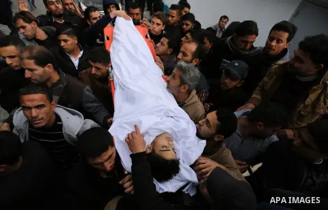 Mourners carry the body of Palestinian Mohammed Al- Dahdouh who was shot dead during clashes with Israeli troops, during his funeral in Gaza city December 24, 2017. Al- Dahdouh who was shot during clashes with the Israel...