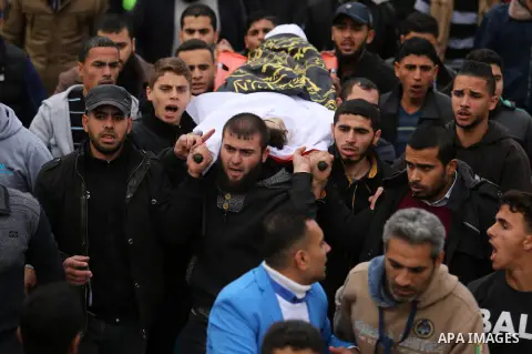 Mourners carry the body of Palestinian Mohammed Al- Dahdouh who was shot dead during clashes with Israeli troops, during his funeral in Gaza city December 24, 2017. Al- Dahdouh who was shot during clashes with the Israel...