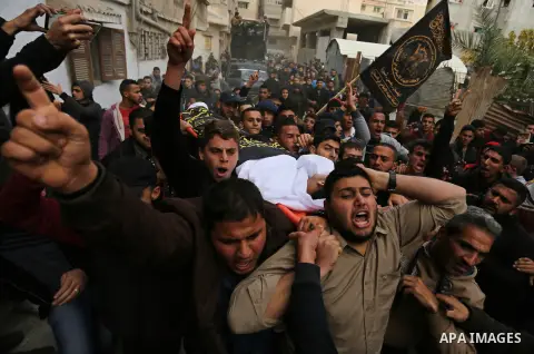 Mourners carry the body of Palestinian Mohammed Al- Dahdouh who was shot dead during clashes with Israeli troops, during his funeral in Gaza city December 24, 2017. Al- Dahdouh who was shot during clashes with the Israel...