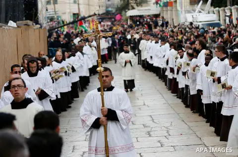 Members of a Palestinian marching band parade during Christmas celebrations outside the Church of the Nativity in the West Bank city of Bethlehem on December 24, 2017. Photo by Wisam Hashlamoun