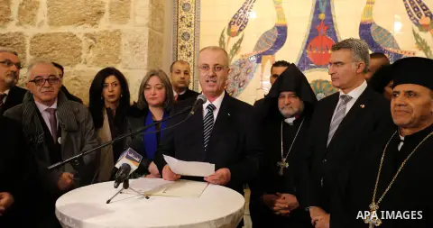 Palestinian Prime Minister, Rami Hamdallah, attends a Christmas midnight mass at the Church of the Nativity in the West Bank city of Bethlehem, December 24, 2017. Photo by Prime Minister Office