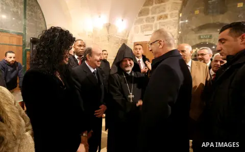 Palestinian Prime Minister, Rami Hamdallah, attends a Christmas midnight mass at the Church of the Nativity in the West Bank city of Bethlehem, December 24, 2017. Photo by Prime Minister Office