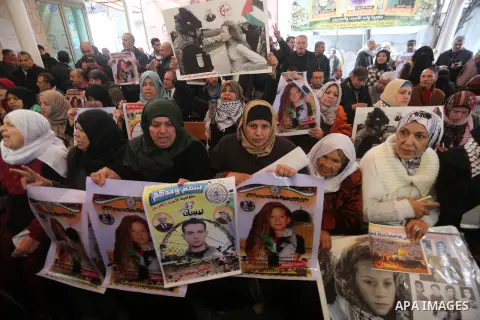 Palestinians hold poster of Ahed Tamimi during a protest to show solidarity with Palestinian prisoners held in Israeli jails, in front of Red cross office in Gaza city, on December 25, 2017. Photo by Mohammed Asad