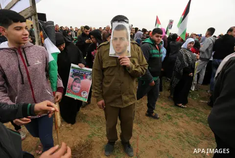 A Palestinian man playing the role of Israeli soldier Oron Shaul stands during a rally in solidarity with Palestinian prisoners held in Israeli jails, in the northern Gaza Strip December 29, 2017. Photo by Ashraf Amra