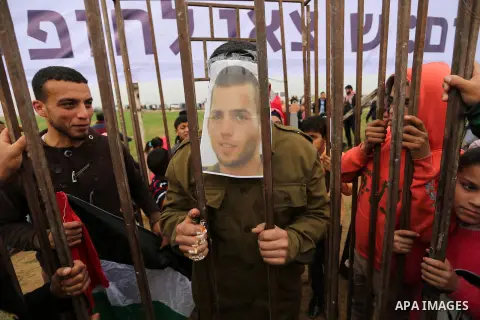 A Palestinian man playing the role of Israeli soldier Oron Shaul stands in a mock jail during a rally in solidarity with Palestinian prisoners held in Israeli jails, in the northern Gaza Strip December 29, 2017. Photo by...