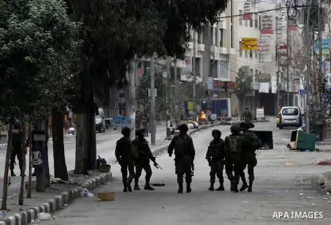 Israeli security forces take position during clashes with Palestinian protesters in the occupied West Bank city of Hebron on December 29, 2017 as protests continue over US President Donald Trump's declaration of Jerusale...