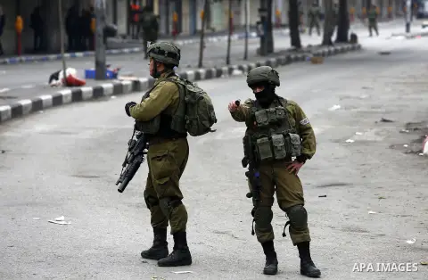 Israeli security forces take position during clashes with Palestinian protesters in the occupied West Bank city of Hebron on December 29, 2017 as protests continue over US President Donald Trump's declaration of Jerusale...