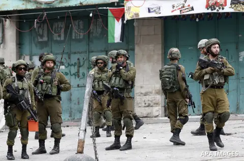 Israeli security forces take position during clashes with Palestinian protesters in the occupied West Bank city of Hebron on December 29, 2017 as protests continue over US President Donald Trump's declaration of Jerusale...