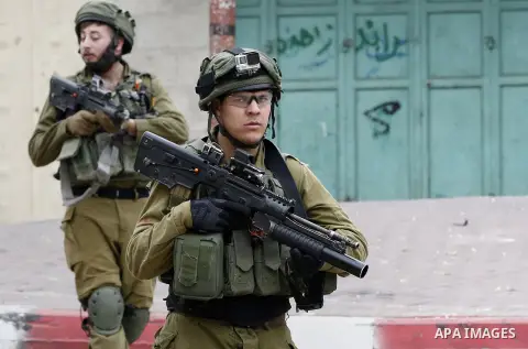 Israeli security forces take position during clashes with Palestinian protesters in the occupied West Bank city of Hebron on December 29, 2017 as protests continue over US President Donald Trump's declaration of Jerusale...