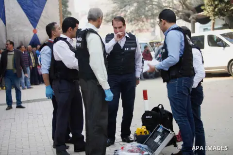 Egyptian forensic policemen inspect the site of a gun attack on Mar Mina church in Helwan district on the outskirts of Cairo, on December 29, 2017. A gunman opened fire on a church, killing at least nine people before po...