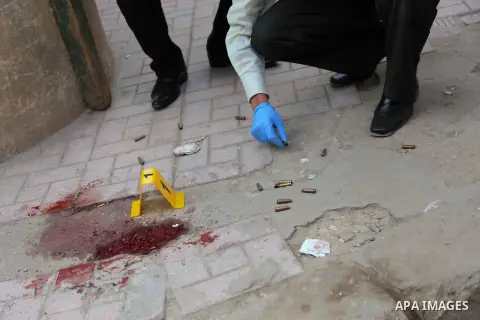 A close up shot shows Egyptian forensic policemen inspecting the site of a gun attack on Mar Mina church in Helwan district on the outskirts of Cairo, on December 29, 2017. A gunman opened fire on a church, killing at le...