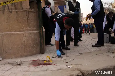 Egyptian forensic policemen inspect the site of a gun attack on Mar Mina church in Helwan district on the outskirts of Cairo, on December 29, 2017. A gunman opened fire on a church, killing at least nine people before po...